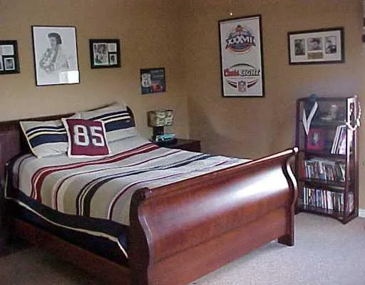 a bedroom with bed and painting on the wall