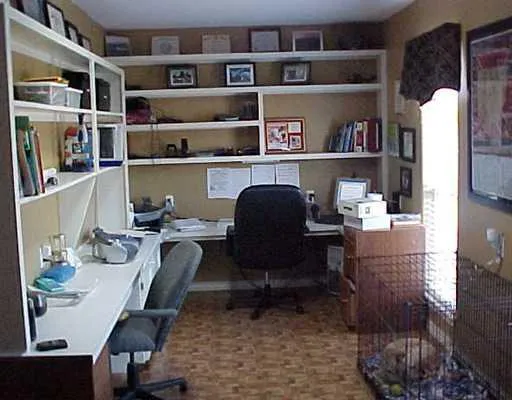 a work room with furniture and a book shelf