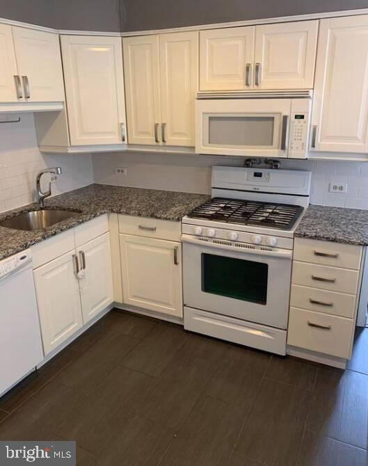 272 Kalos Street Philadelphia, PA 19128 - Photo 2 of 21 a kitchen with granite countertop white cabinets and white appliances