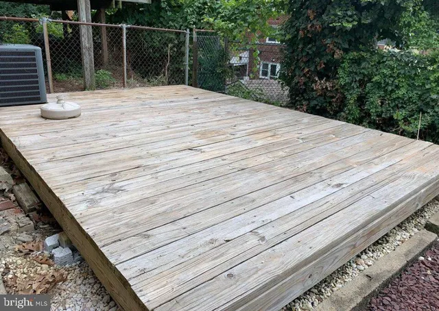 a bedroom with a bed and wooden deck