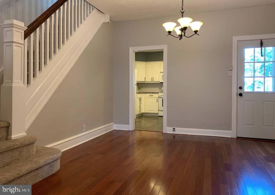272 Kalos Street Philadelphia, PA 19128 - Photo 4 of 21 a view of an empty room with wooden floor and a window