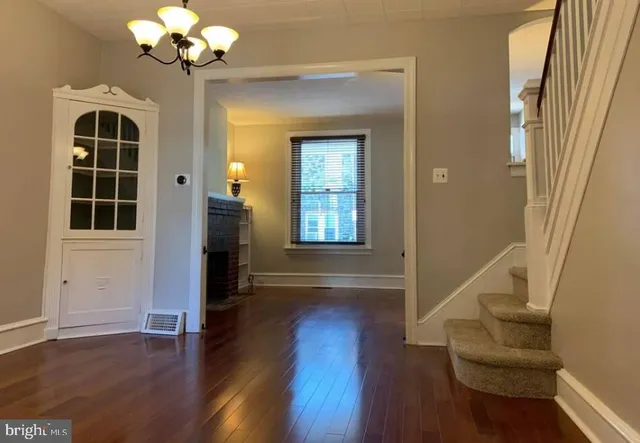 a view of an entryway with wooden floor and a window