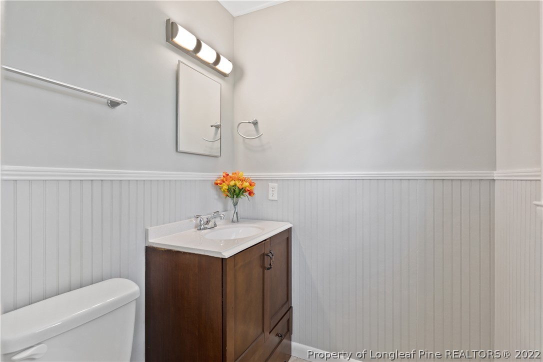 4549 Ruby Road Fayetteville, NC 28311 - Photo 15 of 20 a bathroom with a sink a mirror and a toilet
