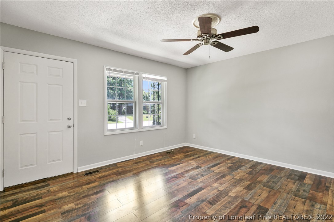 4549 Ruby Road Fayetteville, NC 28311 - Photo 3 of 20 a view of a livingroom with a window and wooden floor