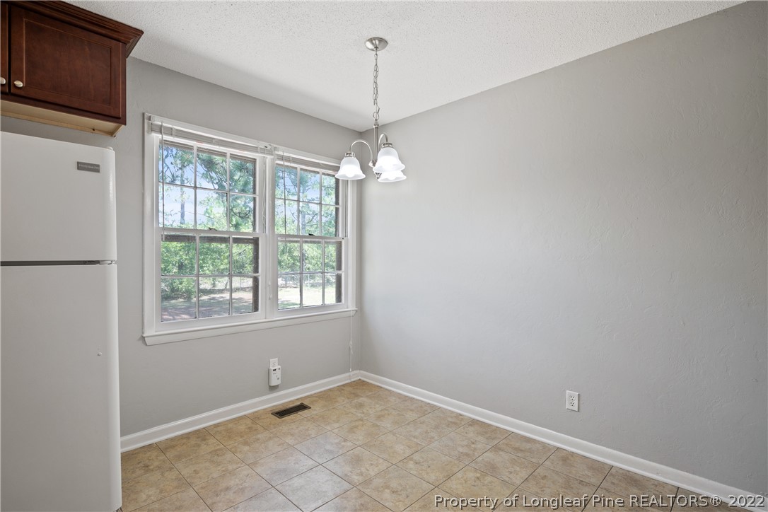 4549 Ruby Road Fayetteville, NC 28311 - Photo 7 of 20 a view of a room with window and chandelier fan