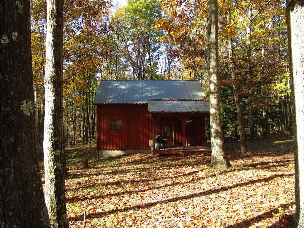 789 Bullion Road, Unit BULLION ROAD Polk, PA 16342 - Photo 3 of 19 a view of a house with large trees and wooden fence