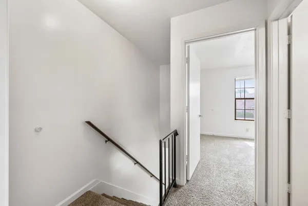 a view of a hallway with a white walls