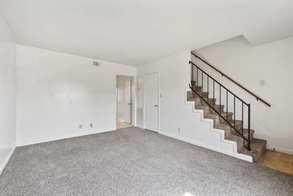 a view of an empty room with stairs