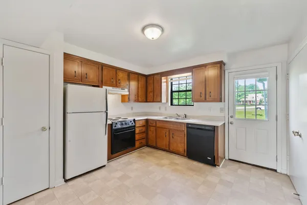 a kitchen with a refrigerator and a sink