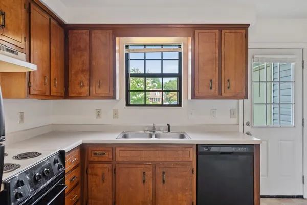 a kitchen with stainless steel appliances granite countertop a sink stove and cabinets