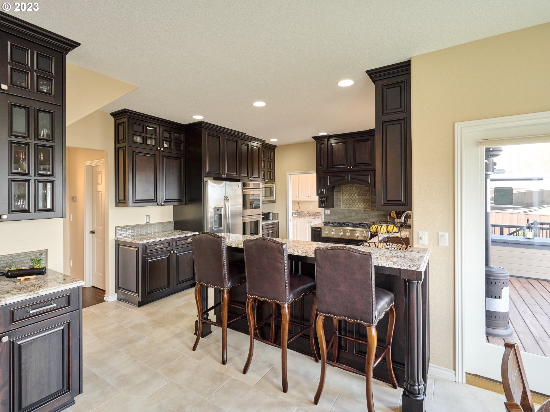 104 Breyonna Way Silverton, OR 97381 - Photo 14 of 45 a kitchen with kitchen island granite countertop wooden cabinets and stainless steel appliances