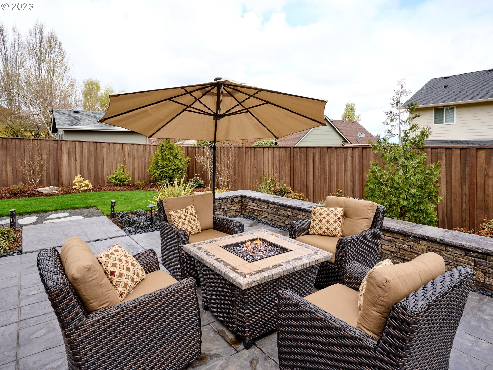 104 Breyonna Way Silverton, OR 97381 - Photo 39 of 45 a view of a patio with couches table and chairs under an umbrella
