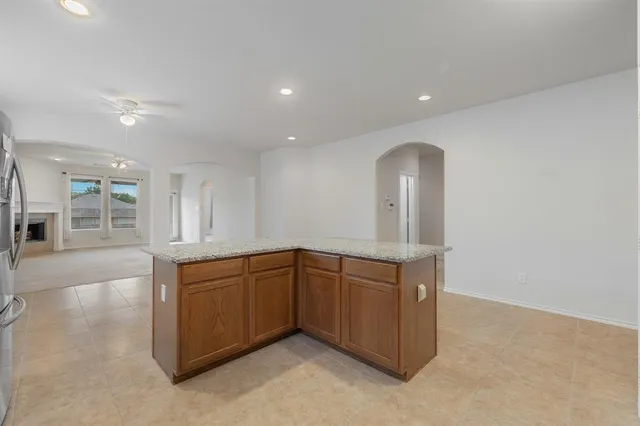 a kitchen with stainless steel appliances granite countertop a sink and a wooden cabinets