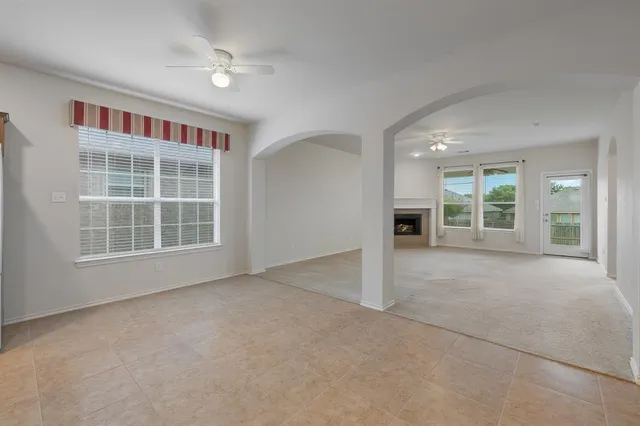 an empty room with windows and cabinet