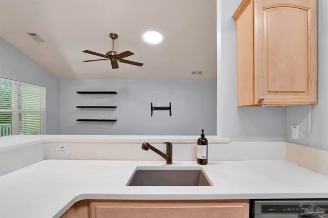 a kitchen with a sink and large window