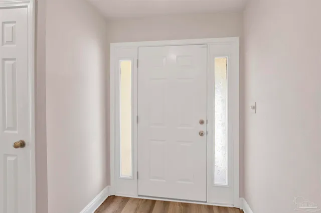 a view of front door with wooden floor