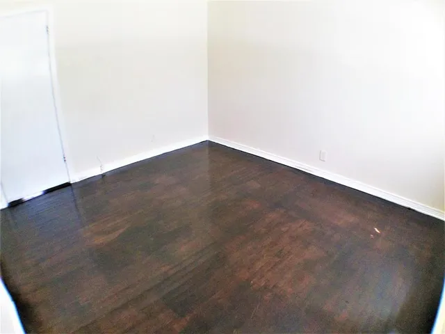 an empty room with wooden floor