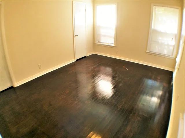 an empty room with wooden floor