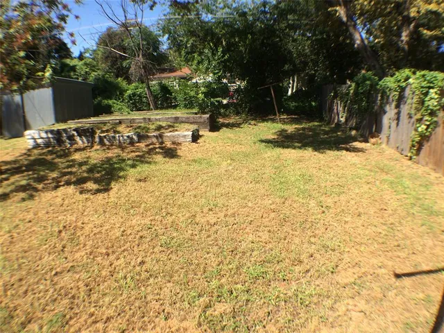a view of a yard with swimming pool