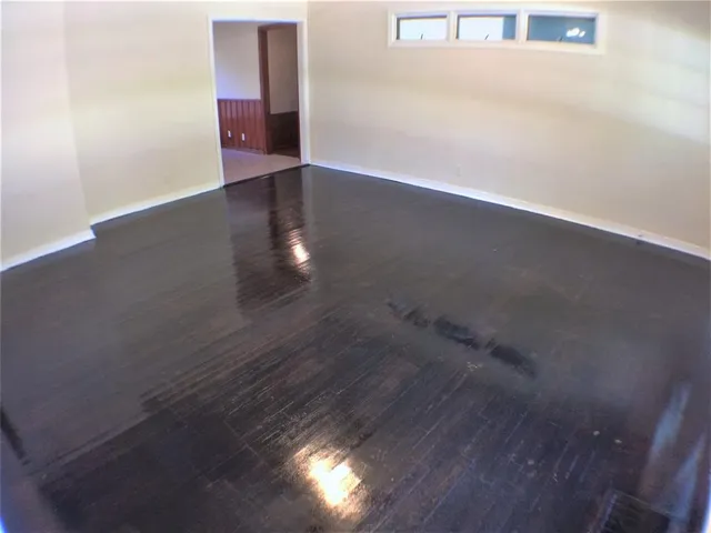 an empty room with wooden floor
