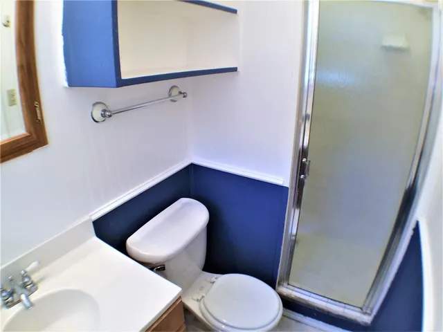 a white toilet sitting next to a bathroom sink