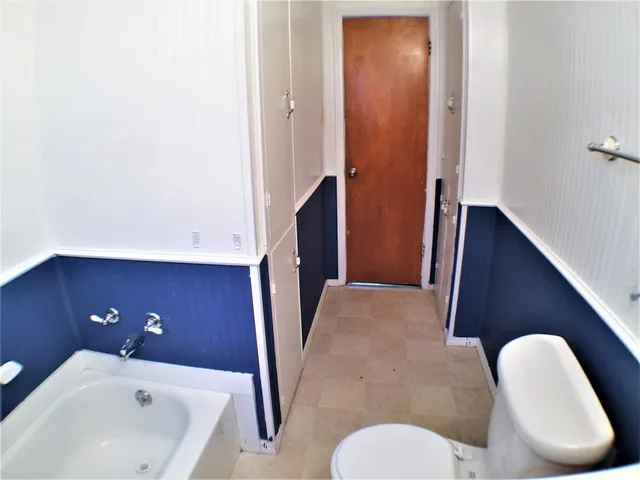 a bathroom with a toilet sink and tub