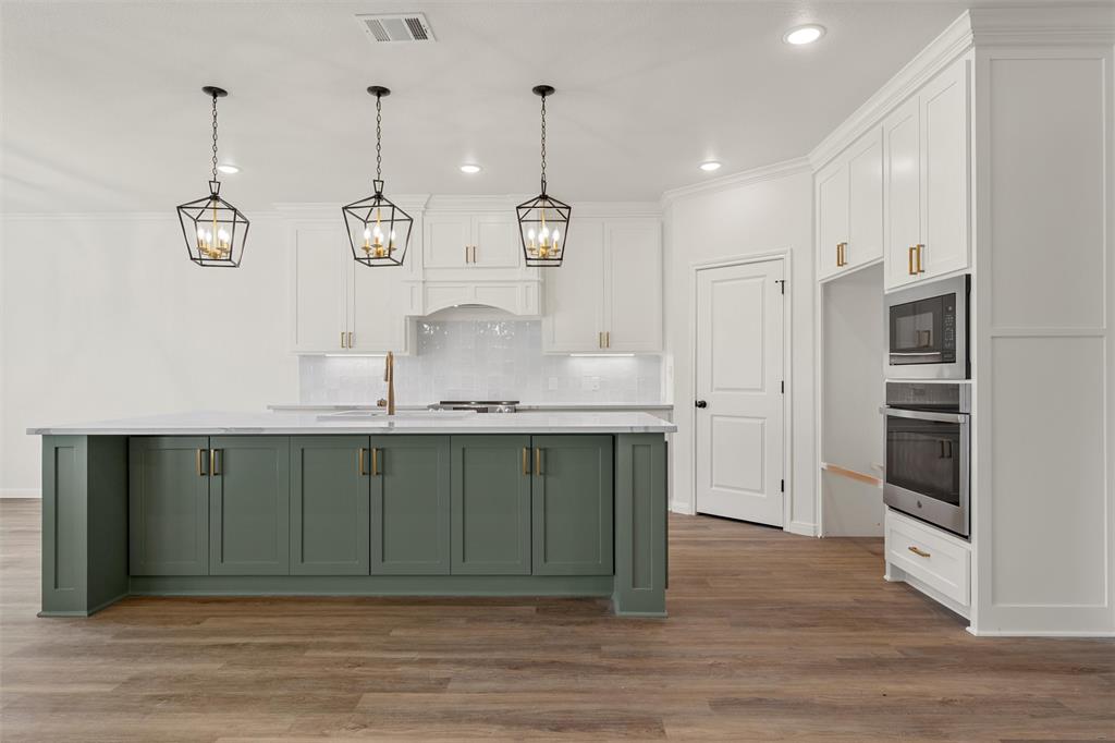 920 Gallant Fox Hewitt, TX 76643 - Photo 2 of 36 a kitchen with stainless steel appliances granite countertop a sink cabinets and wooden floor