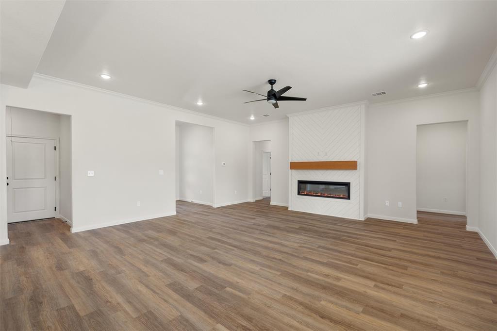 920 Gallant Fox Hewitt, TX 76643 - Photo 6 of 36 a view of an empty room with wooden floor and a window