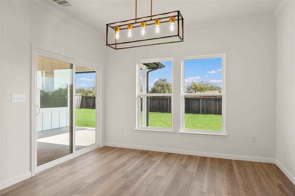 920 Gallant Fox Hewitt, TX 76643 - Photo 9 of 36 an empty room with wooden floor and windows
