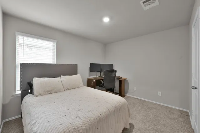 a bedroom with a bed and a tv