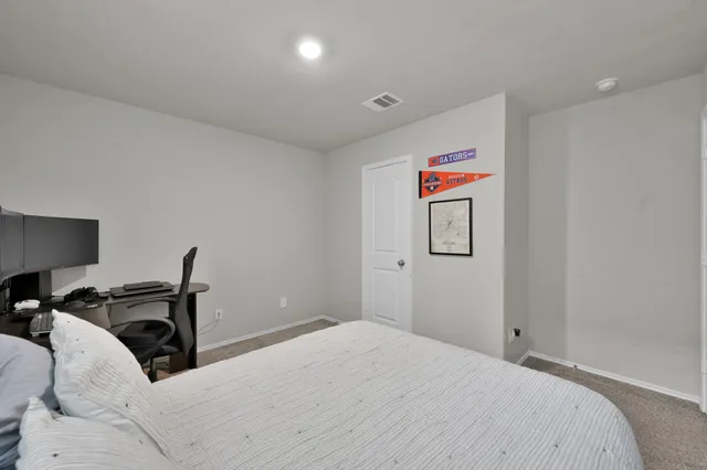 a bedroom with a bed and a lamp