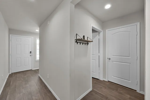 a view of hallway with wooden floor