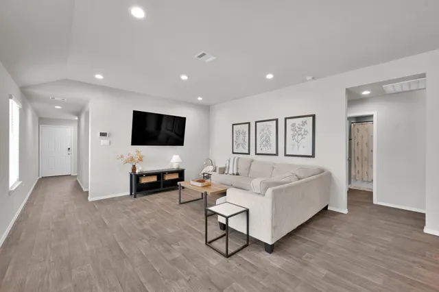 a living room with furniture and a flat screen tv