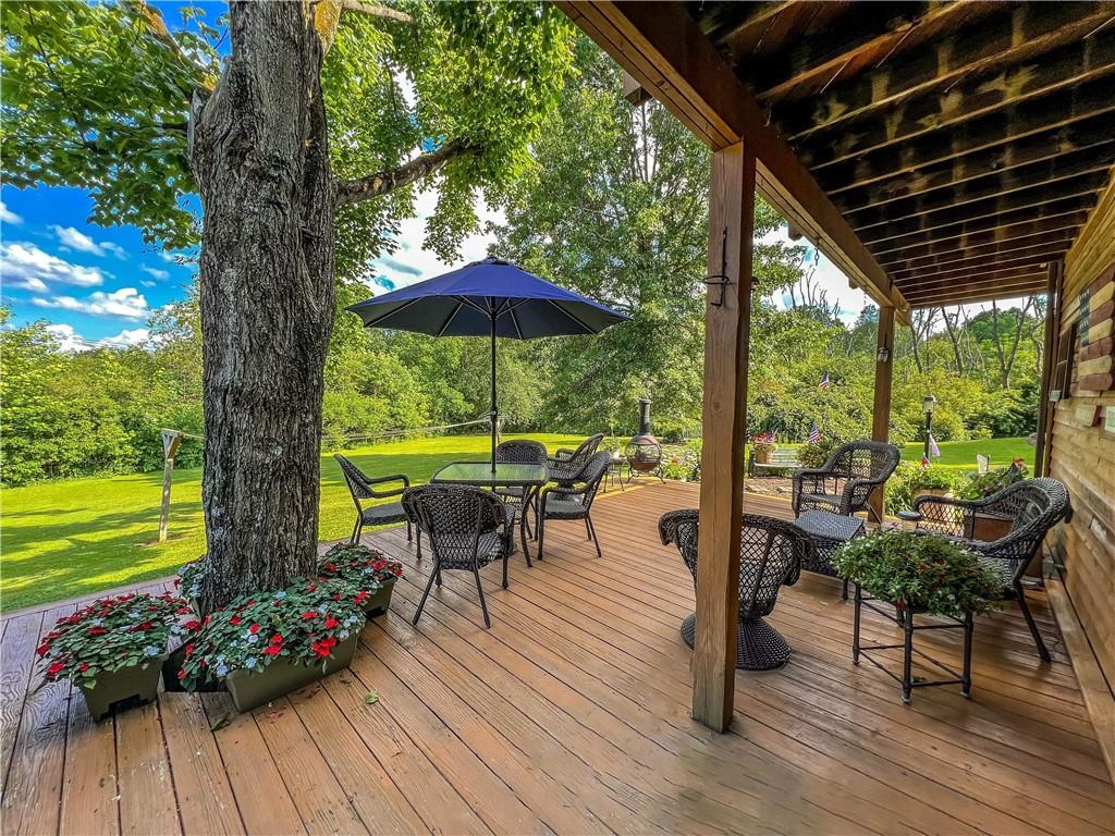 138 Rhoer Road Slippery Rock, PA 16057 - Photo 2 of 23 a view of a swimming pool with wooden floor and outdoor seating