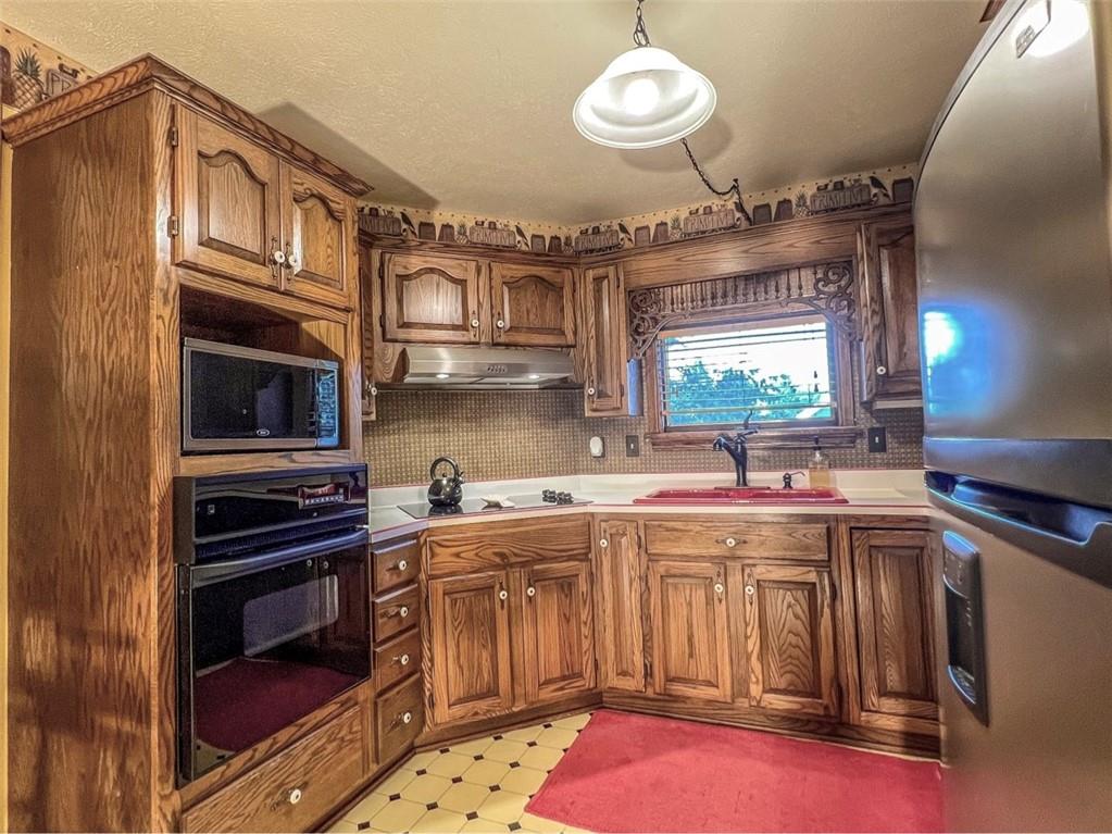 138 Rhoer Road Slippery Rock, PA 16057 - Photo 9 of 23 a kitchen with stainless steel appliances a stove a sink and a microwave