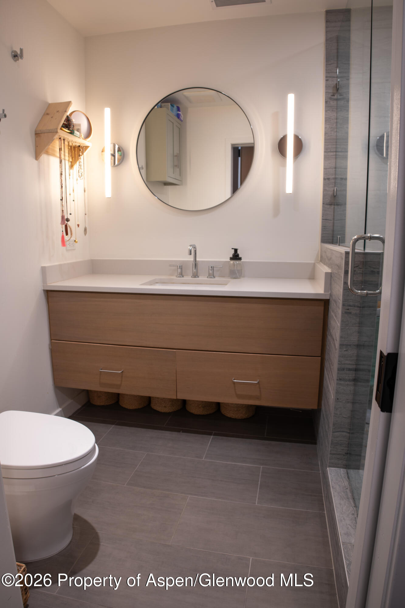 22860 2 Rivers Road, Unit 274 Basalt, CO 81621 - Photo 12 of 13 a bathroom with a toilet a sink and mirror