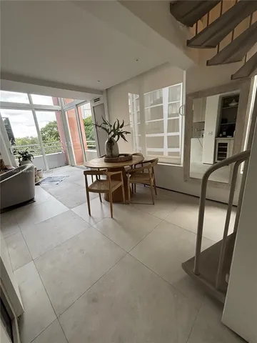 a work room with furniture and large windows