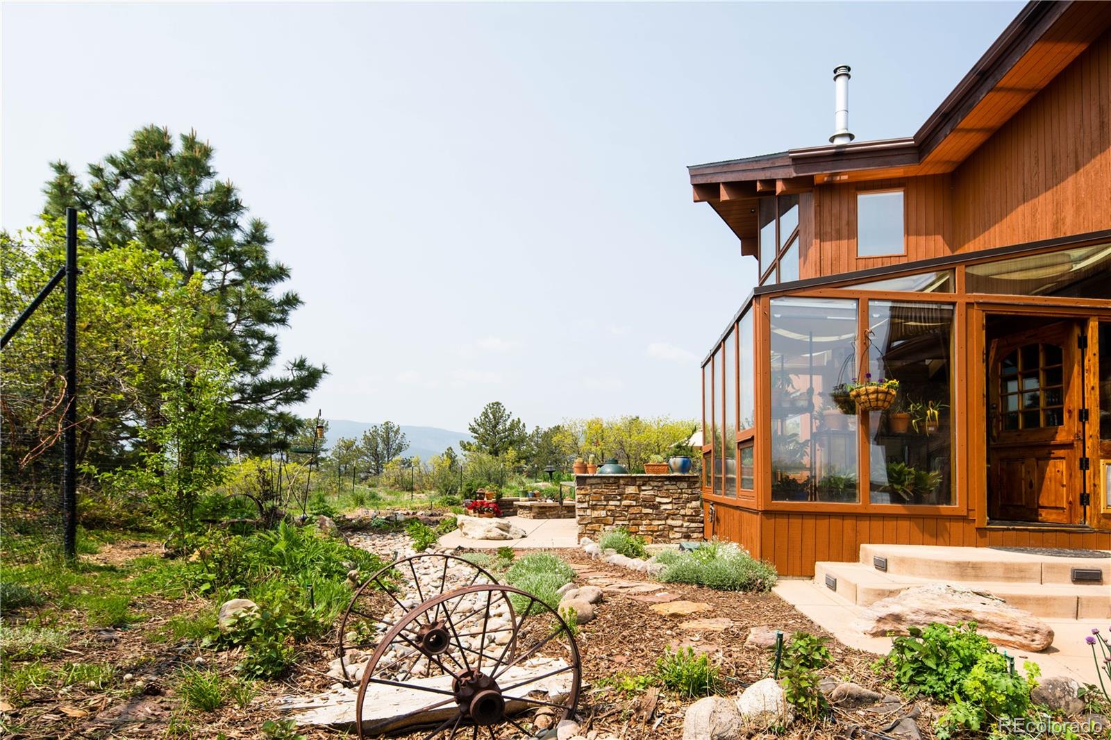 729 Coronado Drive Sedalia, CO 80135 - Photo 12 of 28 a view of a house with backyard porch and patio