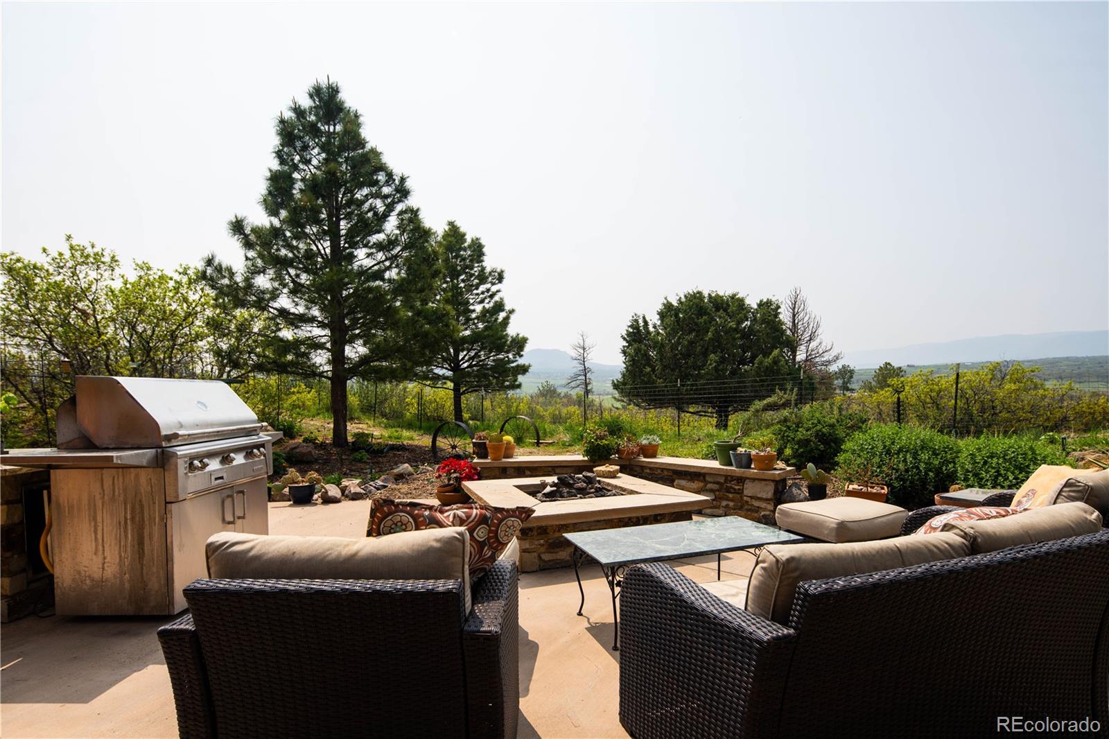 729 Coronado Drive Sedalia, CO 80135 - Photo 13 of 28 a terrace with outdoor seating and trees