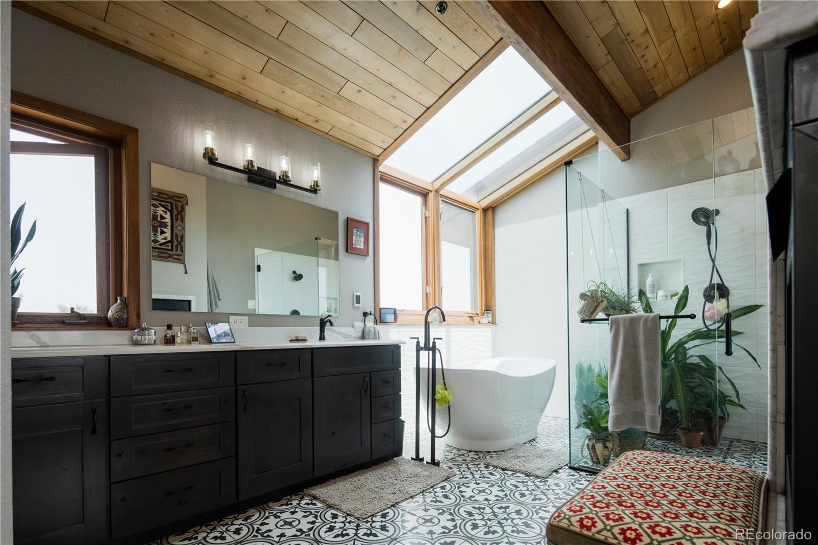 729 Coronado Drive Sedalia, CO 80135 - Photo 20 of 28 a spacious bathroom with a double vanity sink a mirror and a bathtub
