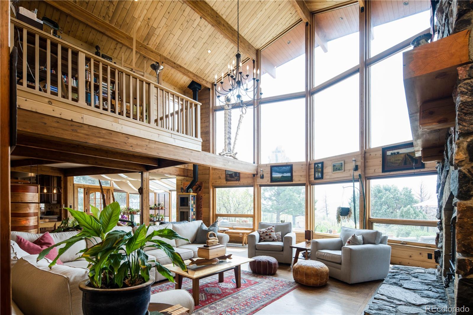 729 Coronado Drive Sedalia, CO 80135 - Photo 2 of 28 a living room filled with furniture and a potted plant