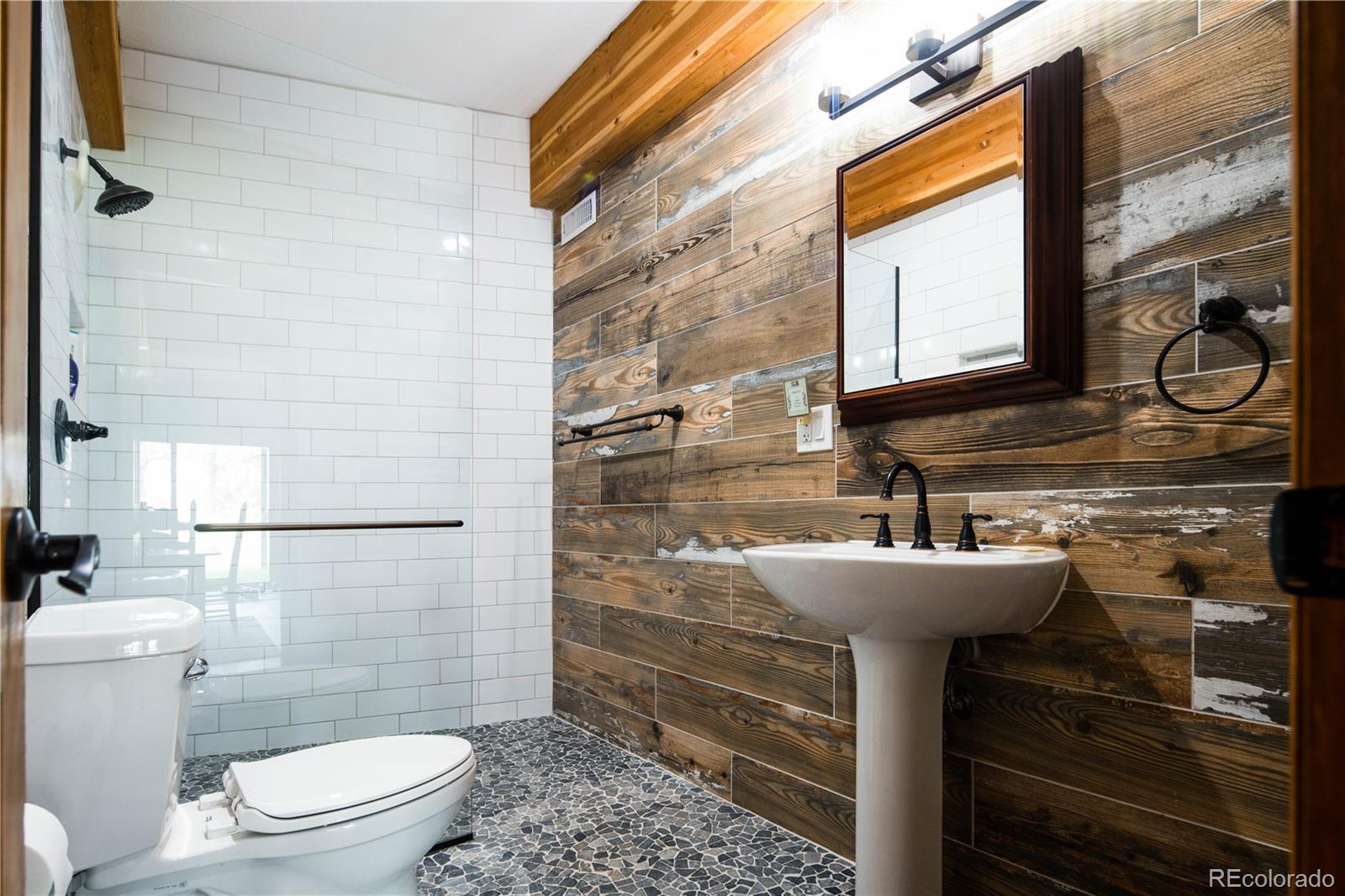 729 Coronado Drive Sedalia, CO 80135 - Photo 25 of 28 a bathroom with a sink toilet and shower