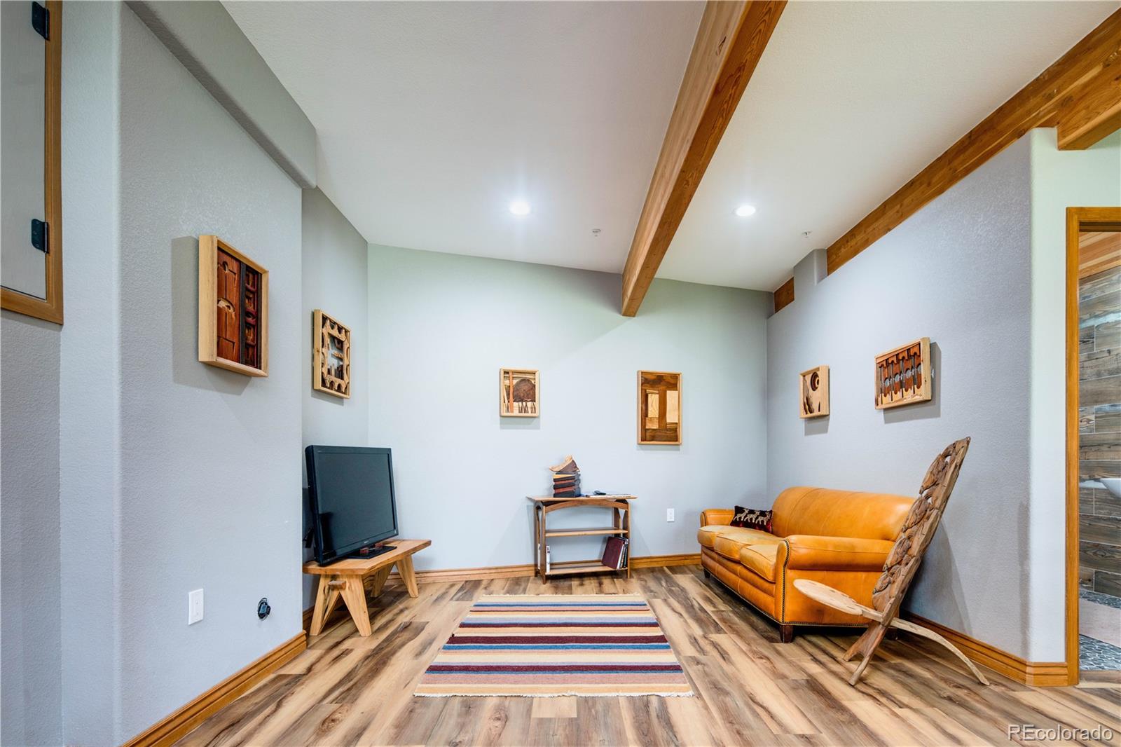 729 Coronado Drive Sedalia, CO 80135 - Photo 26 of 28 a living room with furniture and a flat screen tv