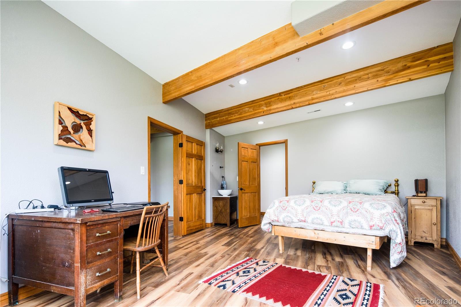 729 Coronado Drive Sedalia, CO 80135 - Photo 27 of 28 a bedroom with furniture and a flat screen tv