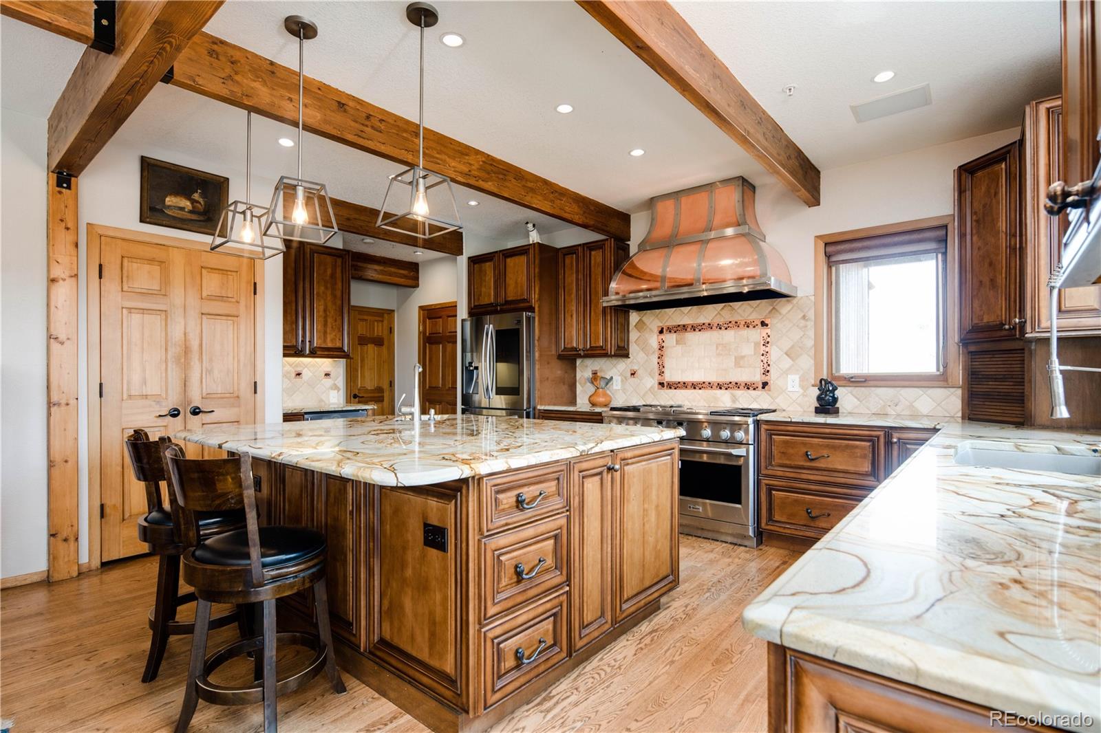 729 Coronado Drive Sedalia, CO 80135 - Photo 4 of 28 a kitchen with stainless steel appliances granite countertop a stove top oven a sink dishwasher and white cabinets with wooden floor