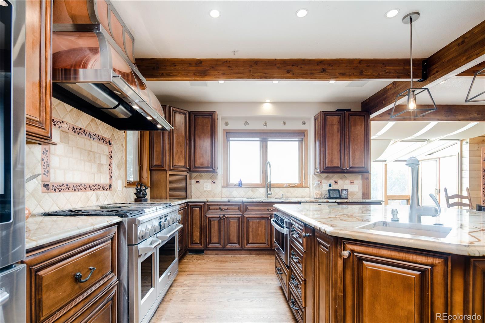 729 Coronado Drive Sedalia, CO 80135 - Photo 6 of 28 a kitchen with stainless steel appliances granite countertop a sink and a stove