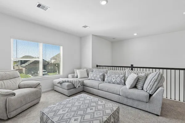 a living room with furniture and a large window