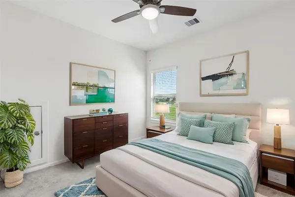 a bedroom with a bed and a dresser