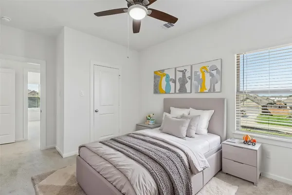 a bedroom with a bed cabinets and window