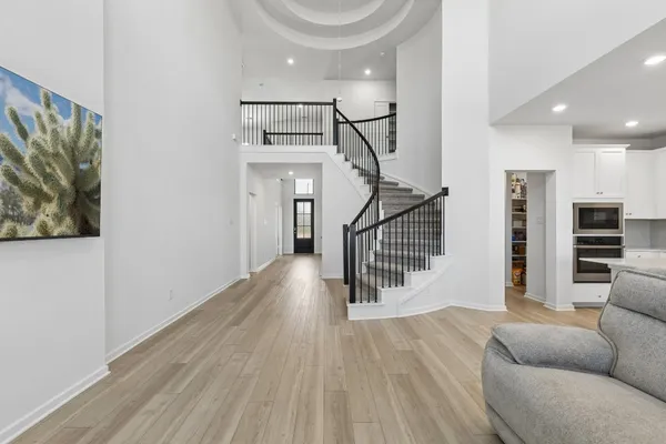 a view of a livingroom with furniture and staircase